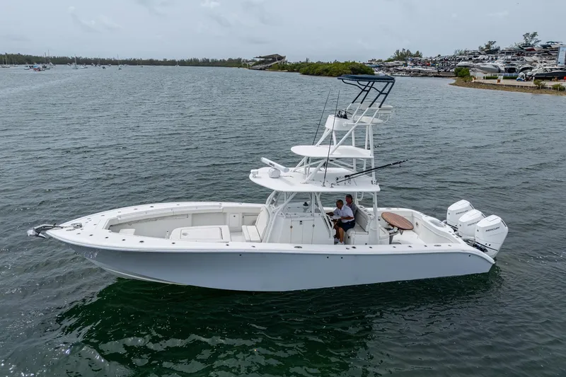 Slide: The Image of 2013 Yellowfin 39 Offshore boat on calm water, side view. - 19