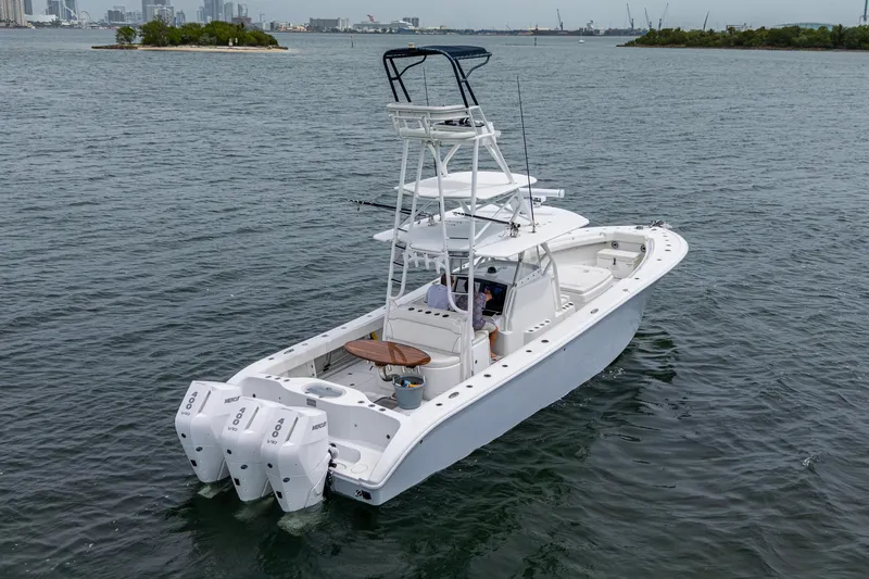 Slide: The Image of 2013 Yellowfin 39 Offshore boat with triple outboard engines on the water. - 23