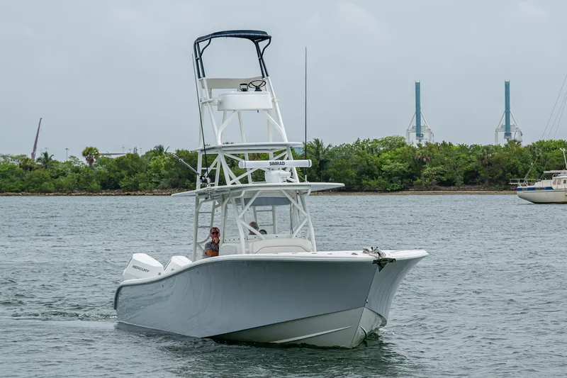 Slide: The Image of 2013 Yellowfin 39 Offshore boat cruising on a calm waterway. - 3