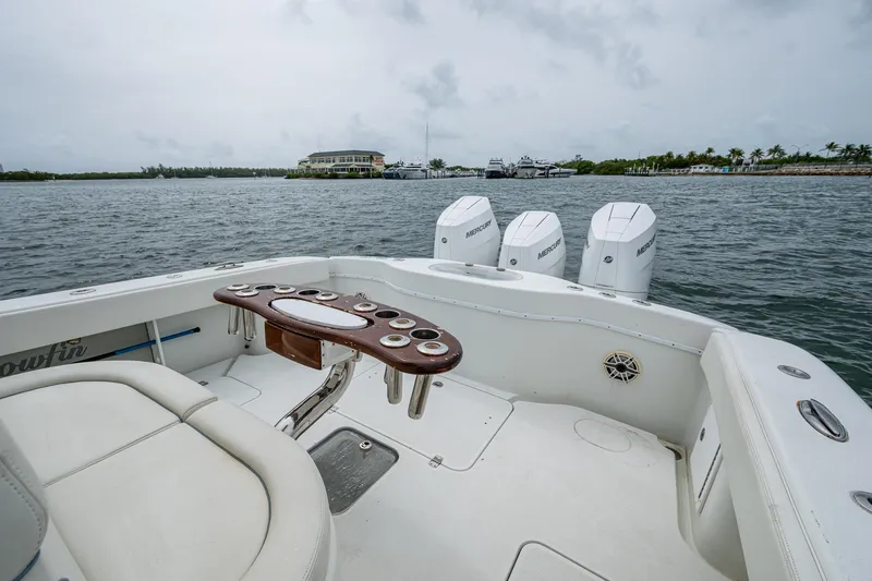 Slide: The Image of 2013 Yellowfin 39 Offshore boat with triple engines on a calm water backdrop. - 30