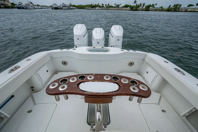 Slide: The Image of 2013 Yellowfin 39 Offshore boat with fishing rod holders, triple engines, and ocean view. - 31