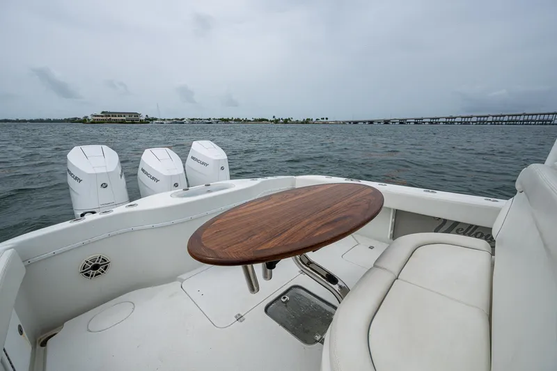 Slide: The Image of 2013 Yellowfin 39 Offshore boat with seating and table on open water. - 33