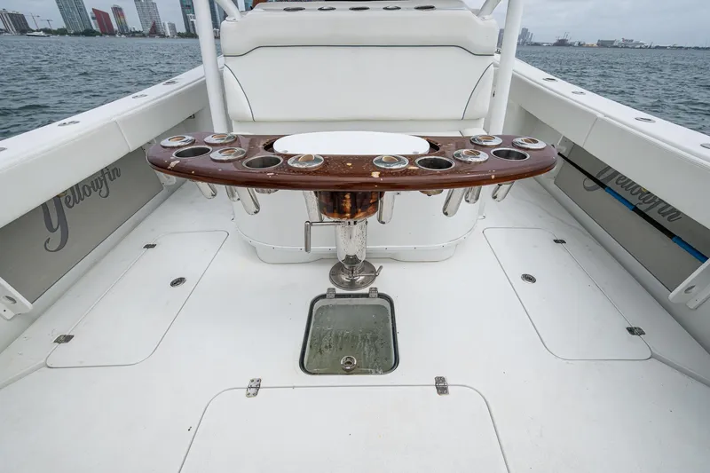 Slide: The Image of 2013 Yellowfin 39 Offshore boat deck with rod holders and seating, on calm water. - 39