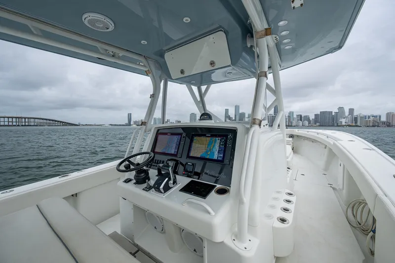 Slide: The Image of 2013 Yellowfin 39 Offshore boat interior with navigation system, city skyline in background. - 44