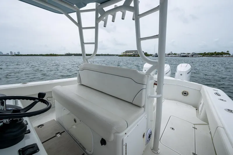 Slide: The Image of 2013 Yellowfin 39 Offshore boat interior with white seating and ocean view. - 47