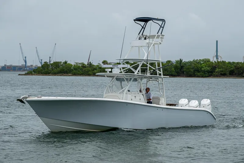 Slide: The Image of 2013 Yellowfin 39 Offshore boat cruising on a calm waterway. - 6