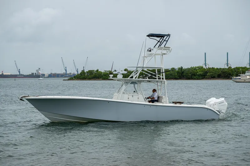 Slide: The Image of 2013 Yellowfin 39 Offshore boat cruising on a calm waterway. - 7
