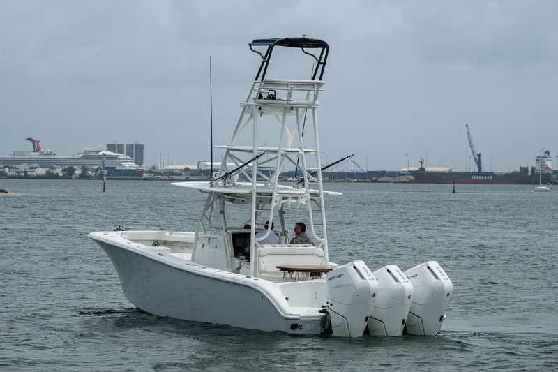 Slide: The Image of 2013 Yellowfin 39 Offshore boat with triple outboard engines on the water. - 9