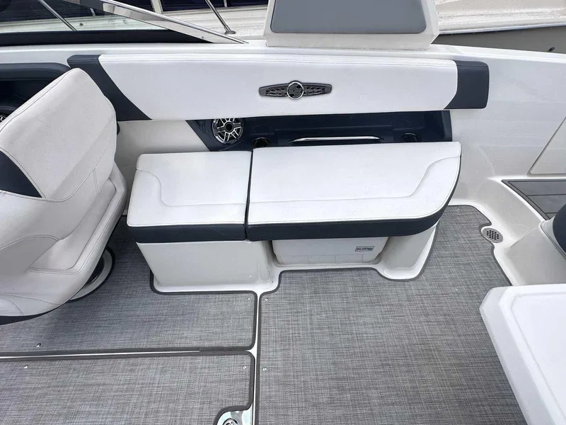 Slide: The Image of 2021 Chaparral 30 Surf boat interior with white seating and gray flooring. - 16