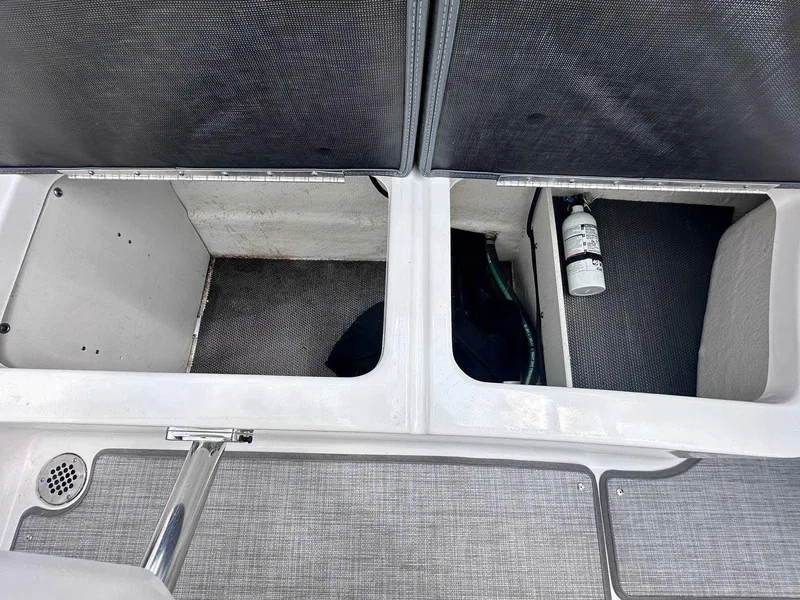 Slide: The Image of 2021 Chaparral 30 Surf boat storage compartments with safety equipment. - 18