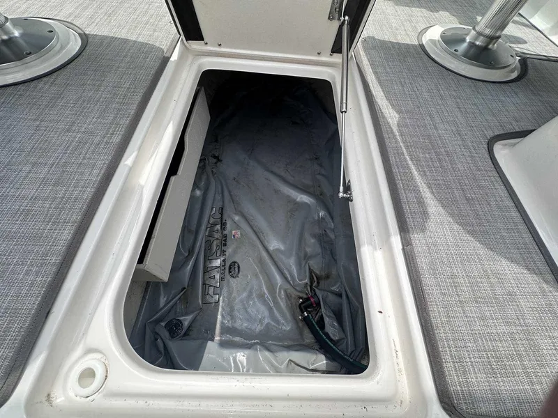 Slide: The Image of Open storage compartment on 2021 Chaparral 30 Surf boat deck. - 19
