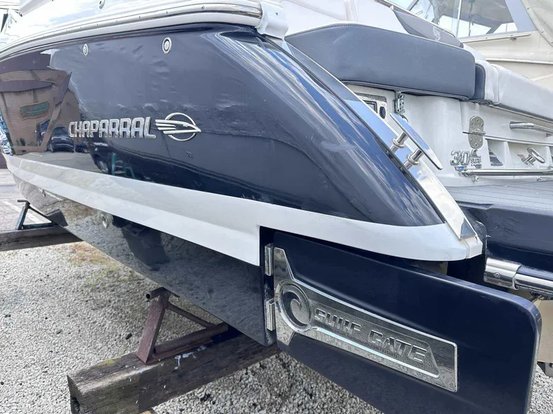 Slide: The Image of 2021 Chaparral 30 Surf boat rear view, featuring sleek design and branding details. - 2