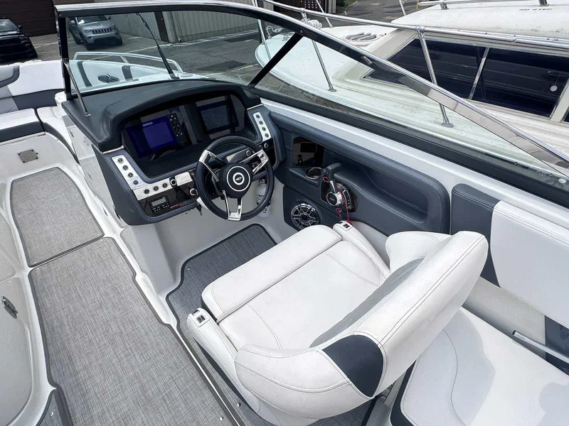 Slide: The Image of 2021 Chaparral 30 Surf boat cockpit with modern steering and control panel. - 25