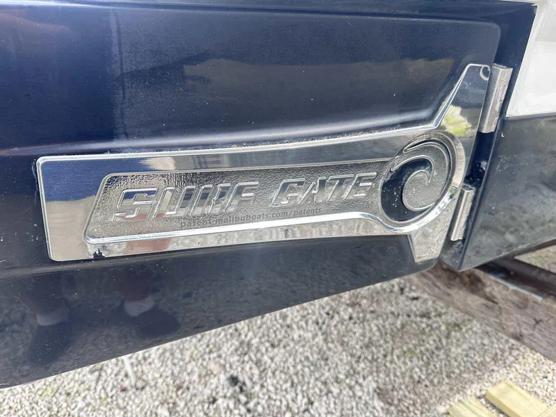 Slide: The Image of 2021 Chaparral 30 Surf boat with chrome 'Surf Gate' detail on the hull. - 3