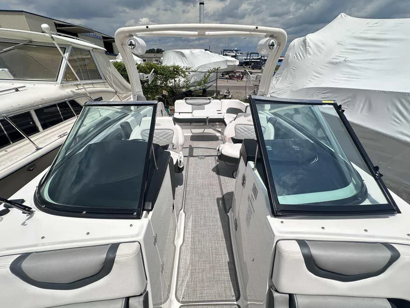 Slide: The Image of 2021 Chaparral 30 Surf boat with open deck, sleek design, and modern seating. - 30