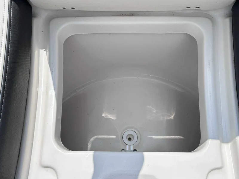 Slide: The Image of Storage compartment in 2021 Chaparral 30 Surf boat, featuring a clean, white interior. - 40