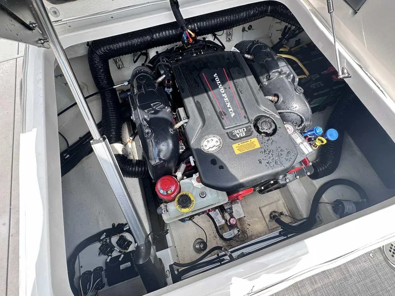 Slide: The Image of Engine compartment of a 2021 Chaparral 30 Surf boat, showcasing a powerful inboard motor. - 42