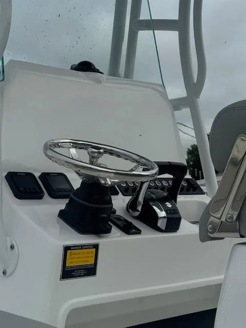 Slide: The Image of 2025 Cape Horn 22 OS boat console with steering wheel and controls. - 16