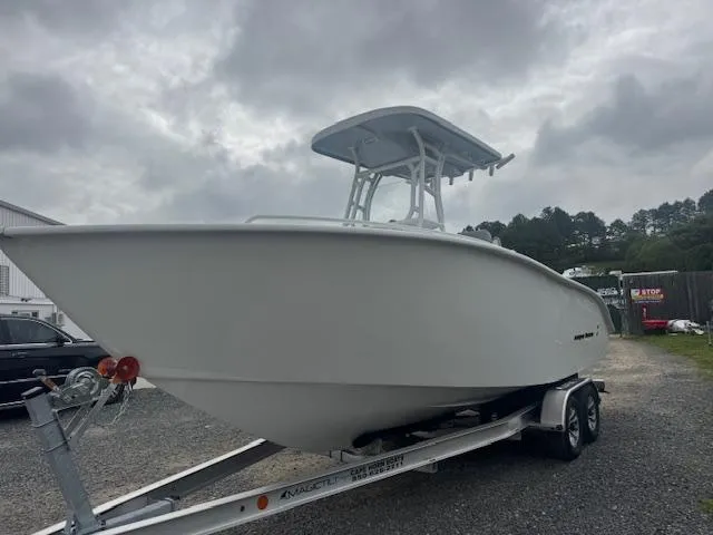 Slide: The Image of 2025 Cape Horn 22 OS boat on trailer under cloudy sky. - 18