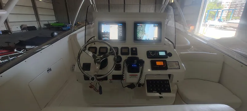 Slide: The Image of 2012 Intrepid 400 Cuddy boat cockpit with navigation screens and steering wheel. - 12