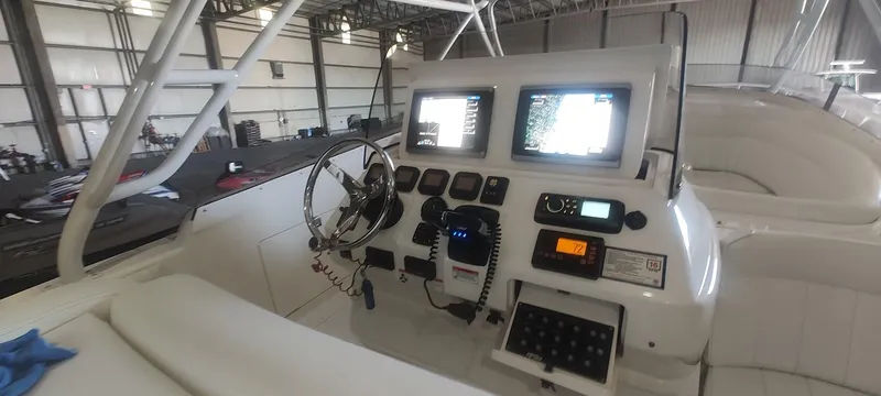 Slide: The Image of Cockpit of 2012 Intrepid 400 Cuddy with advanced navigation displays and controls. - 15