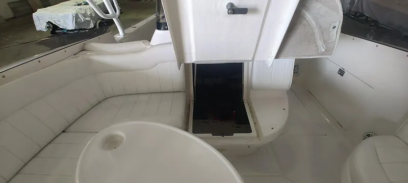 Slide: The Image of 2012 Intrepid 400 Cuddy interior with white seating and storage compartment. - 19