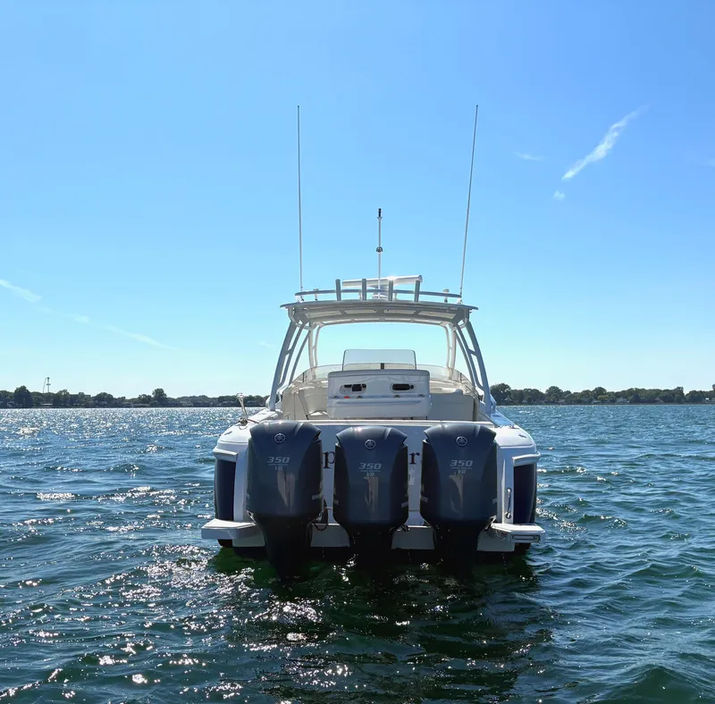 Slide: The Image of 2012 Intrepid 400 Cuddy boat with triple 350 engines on open water. - 2