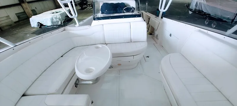 Slide: The Image of 2012 Intrepid 400 Cuddy boat interior with white seating and table. - 24