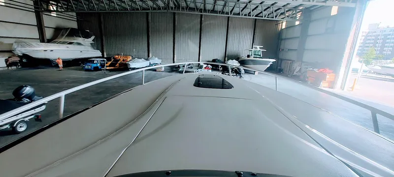 Slide: The Image of 2012 Intrepid 400 Cuddy boat in a spacious indoor storage facility. - 26