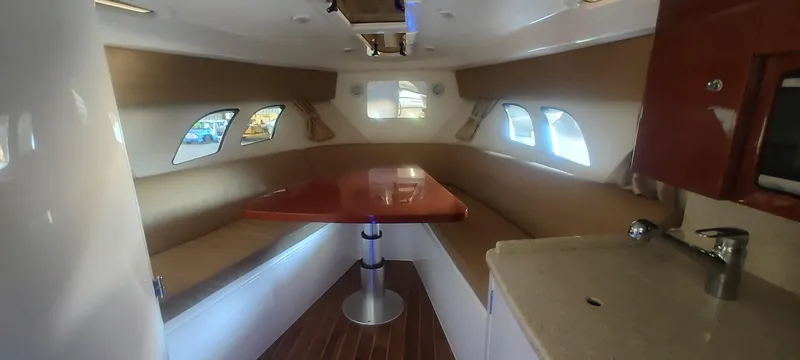 Slide: The Image of Interior of 2012 Intrepid 400 Cuddy with seating and table, featuring modern design. - 27