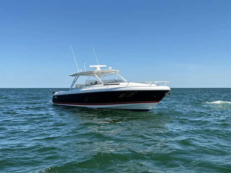 Slide: The Image of 2012 Intrepid 400 Cuddy boat on open sea under clear blue sky. - 3