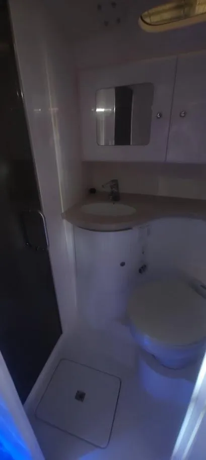 Slide: The Image of Bathroom interior of 2012 Intrepid 400 Cuddy boat, featuring sink and toilet. - 30