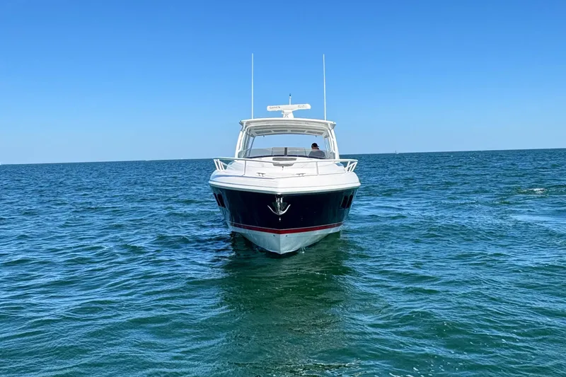 Slide: The Image of 2012 Intrepid 400 Cuddy boat on open sea under clear blue sky. - 4