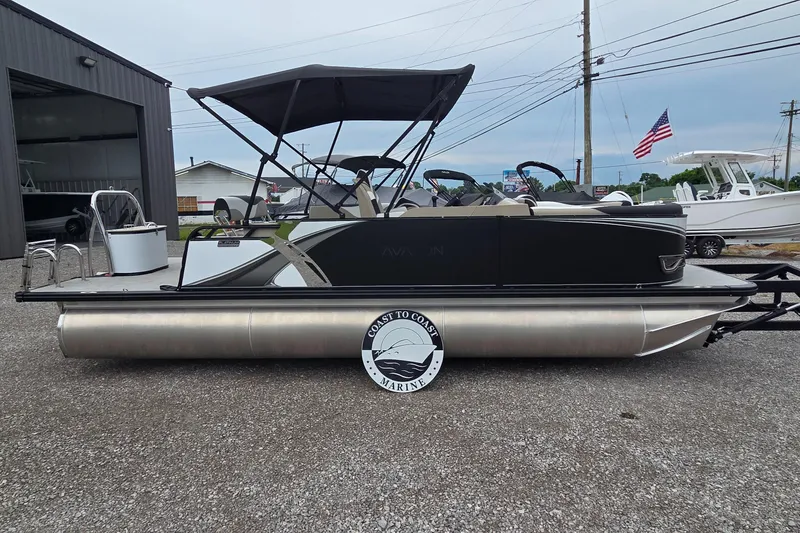 The Image of 2025 Avalon Platinum LSZ 2385 Cruise Rear Bench pontoon boat with canopy, parked outdoors. - 0