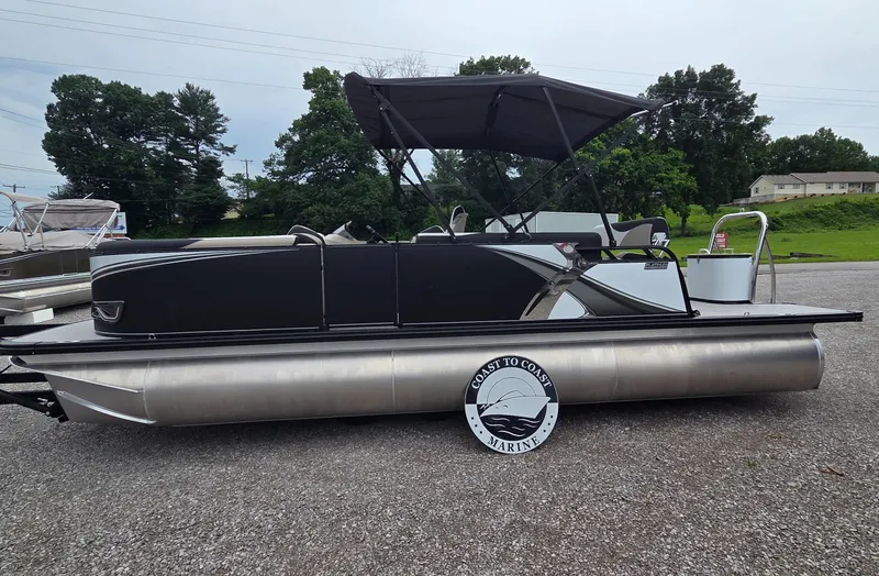 Slide: The Image of 2025 Avalon Platinum LSZ 2385 Cruise Rear Bench pontoon boat with sleek black design. - 2