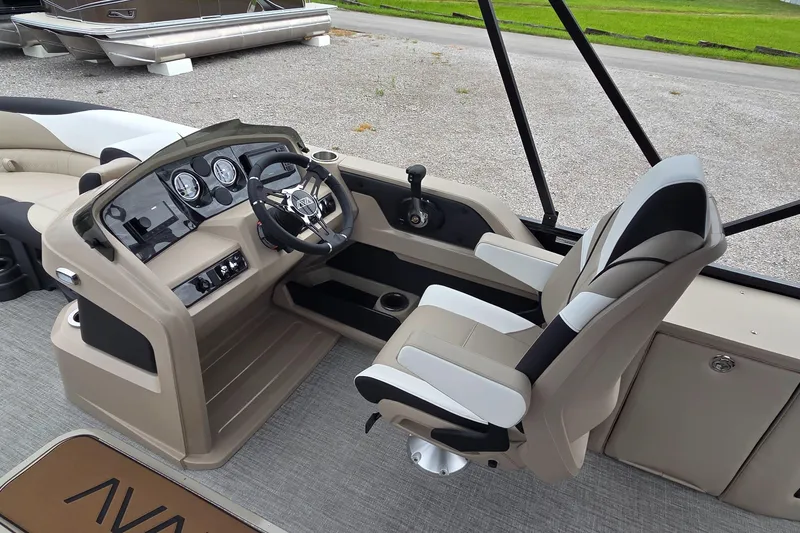 Slide: The Image of 2025 Avalon Platinum LSZ 2385 Cruise Rear Bench boat interior with modern helm and captain's chair. - 6