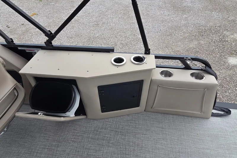 Slide: The Image of 2025 Avalon Platinum LSZ 2385 Cruise Rear Bench interior with cup holders and storage. - 9