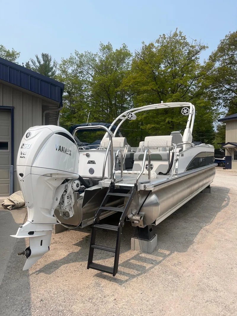 The Image of 2025 Avalon 2585 Catalina Quad Lounger Shift pontoon boat with Yamaha outboard motor, parked outdoors. - 1