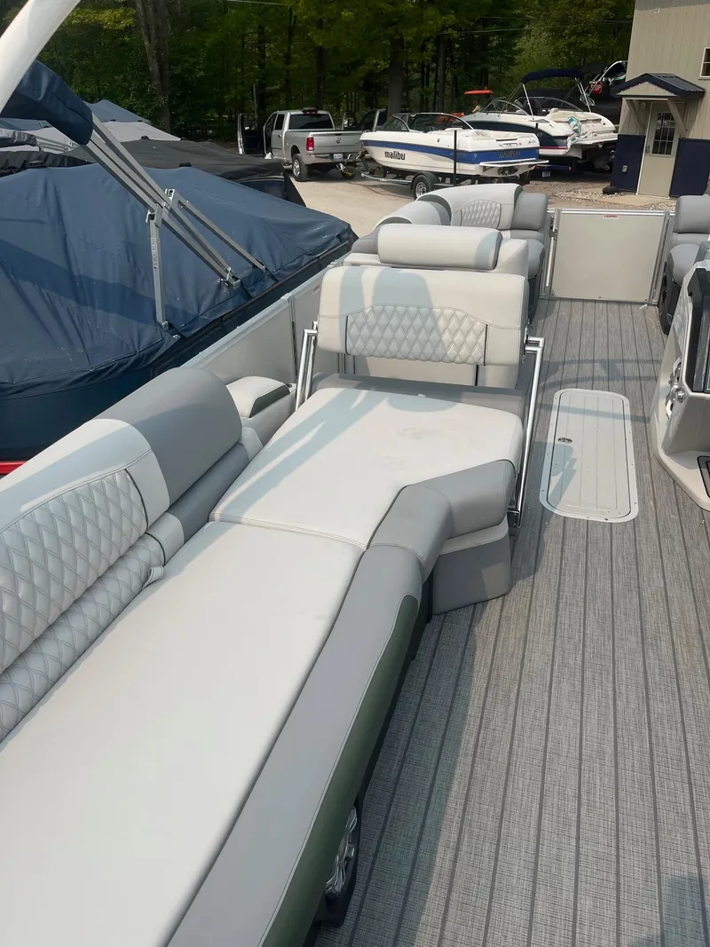 Slide: The Image of 2025 Avalon 2585 Catalina Quad Lounger Shift with luxurious seating on a docked boat. - 14