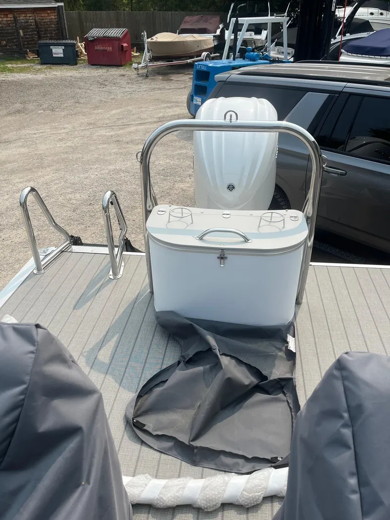 Slide: The Image of 2025 Avalon 2585 Catalina Quad Lounger Shift boat deck with storage and railing. - 17