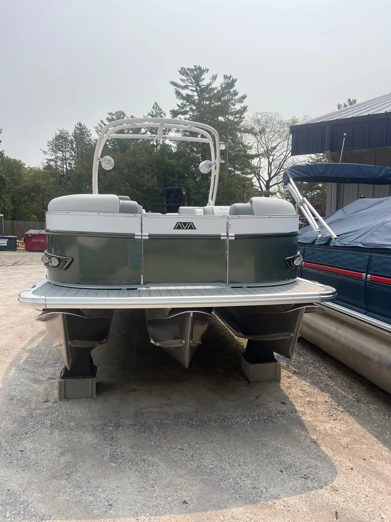 Slide: The Image of 2025 Avalon 2585 Catalina Quad Lounger Shift pontoon boat in a marina setting. - 2