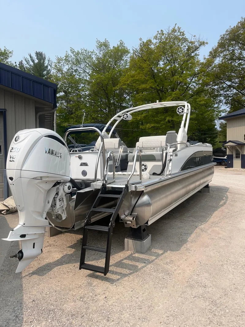 Slide: The Image of 2025 Avalon 2585 Catalina Quad Lounger Shift pontoon boat with Yamaha engine, parked outdoors. - 4