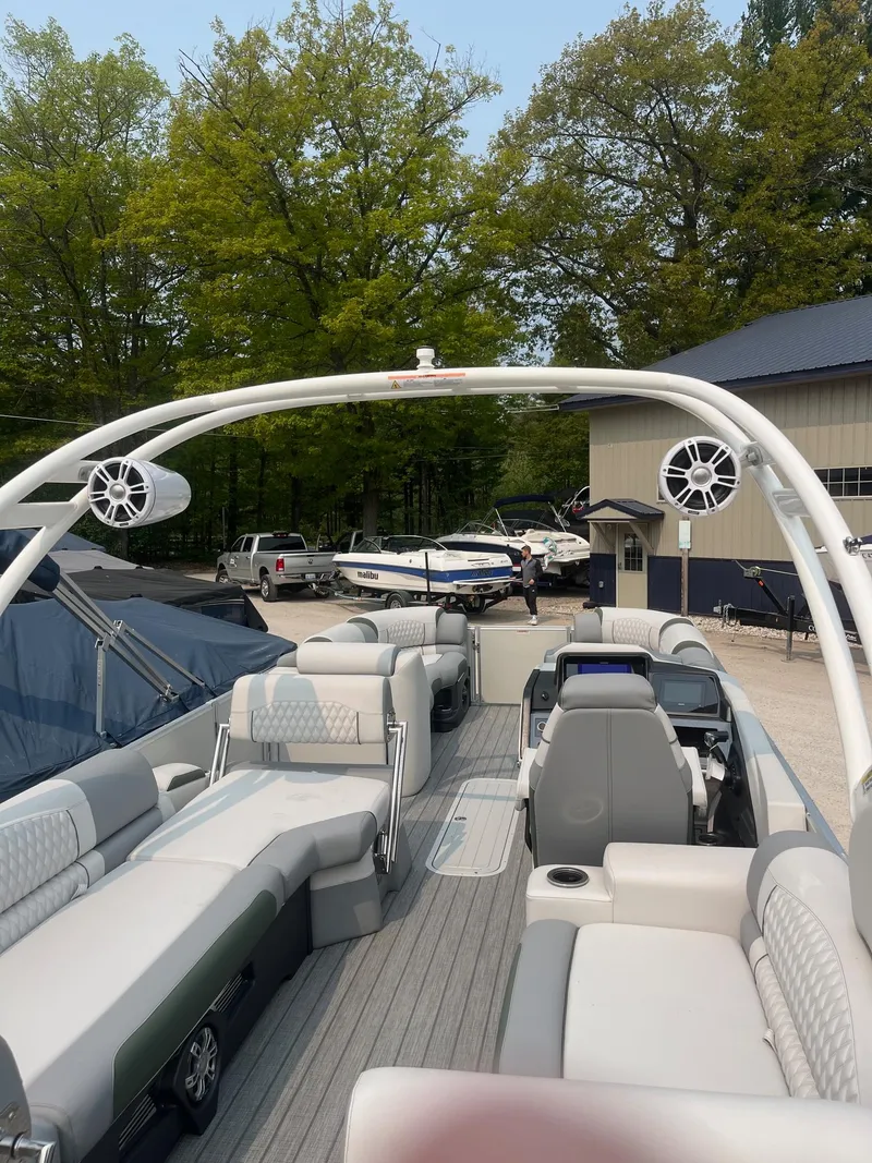 Slide: The Image of 2025 Avalon 2585 Catalina Quad Lounger Shift boat with spacious seating, docked outdoors. - 6