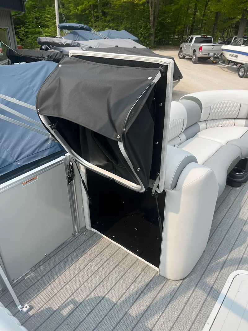 Slide: The Image of 2025 Avalon 2585 Catalina Quad Lounger Shift with open storage compartment on deck. - 9