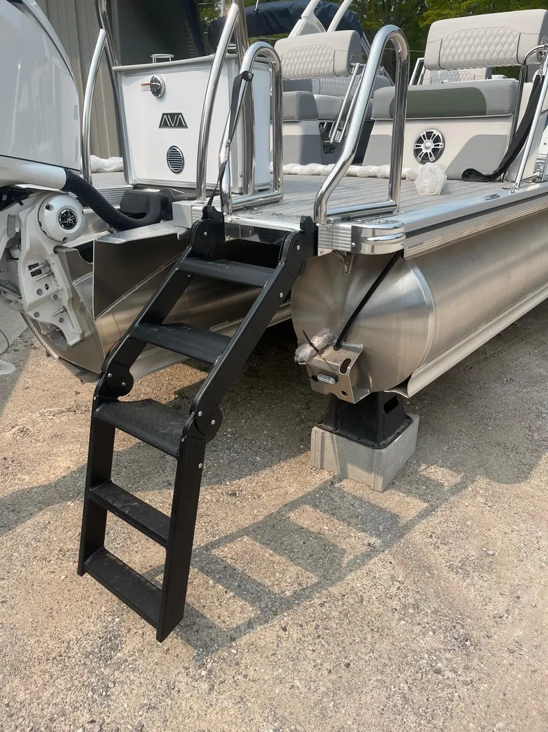 Slide: The Image of 2025 Avalon 2585 Catalina Quad Lounger Shift with boarding ladder on sandy shore. - 5