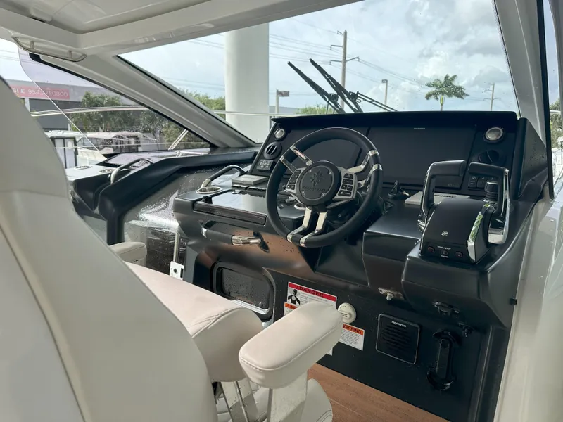 Slide: The Image of 2024 Jeanneau DB 43 helm with modern controls and steering wheel, featuring sleek design. - 21