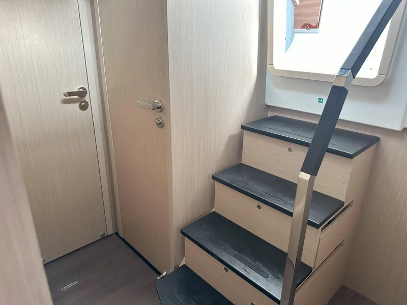 Slide: The Image of 2024 Jeanneau DB 43 interior stairs with wooden finish and modern design. - 25