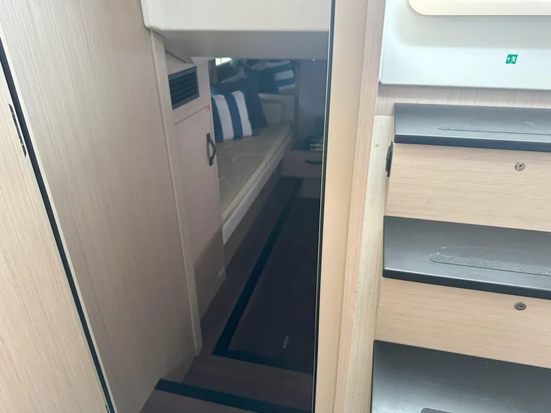 Slide: The Image of 2024 Jeanneau DB 43 interior with modern wood finish and cozy seating area. - 26