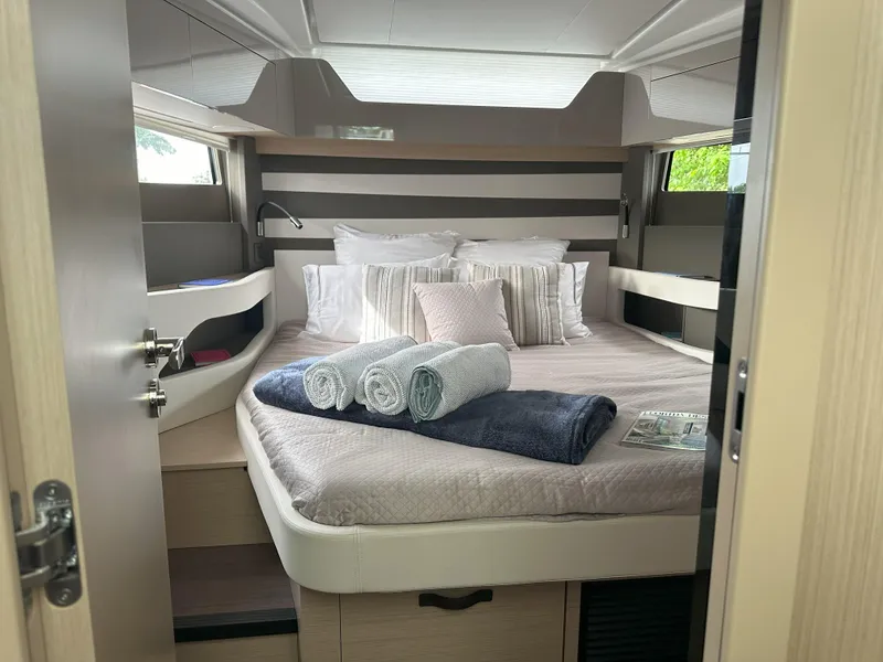 Slide: The Image of Luxurious cabin interior of 2024 Jeanneau DB 43 yacht with neatly arranged bed and towels. - 28