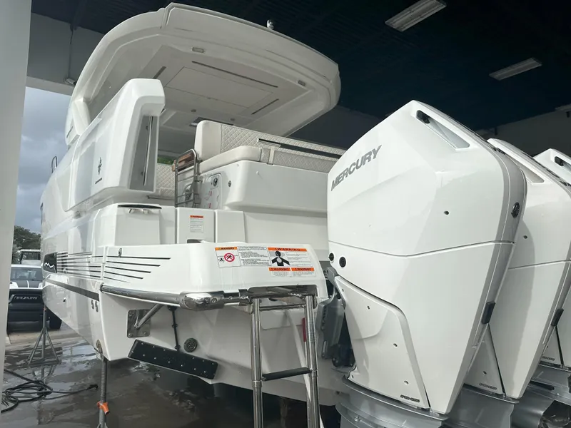 Slide: The Image of 2024 Jeanneau DB 43 boat with Mercury outboard engines, rear view in a showroom. - 3